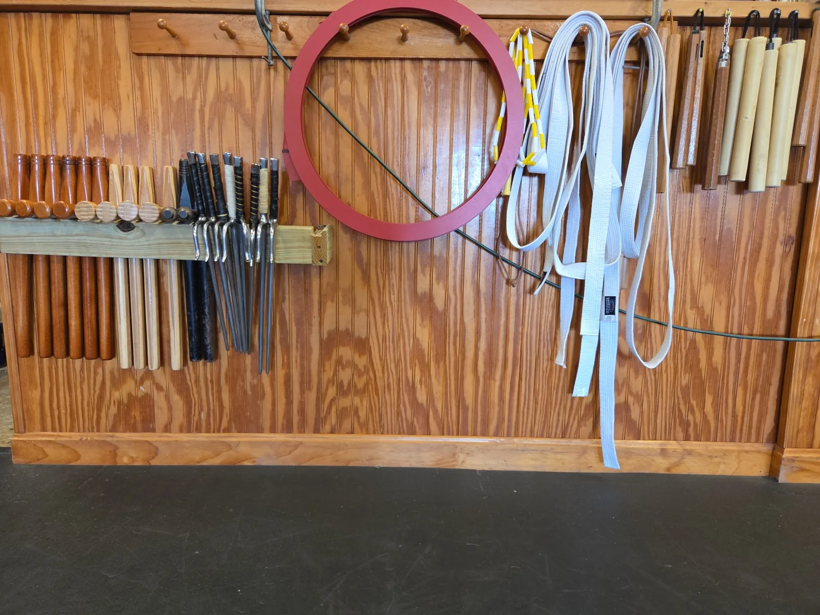 Traditional martial arts training equipment and weapons inside the Zanshin dojo