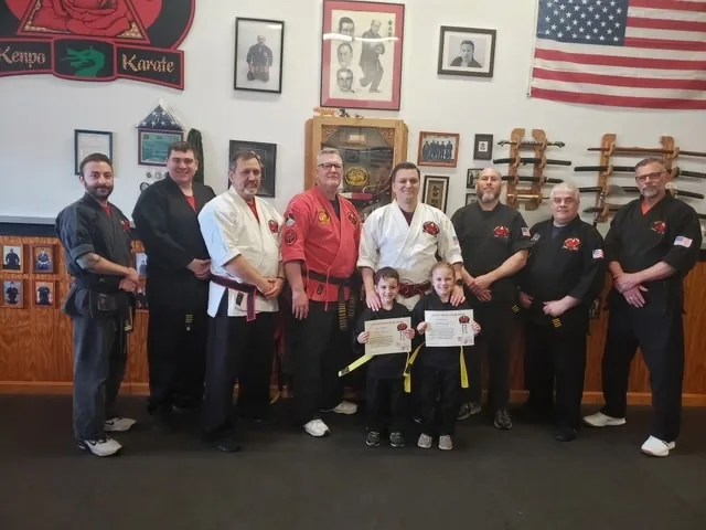 Zanshin test board with two students receiving new belts